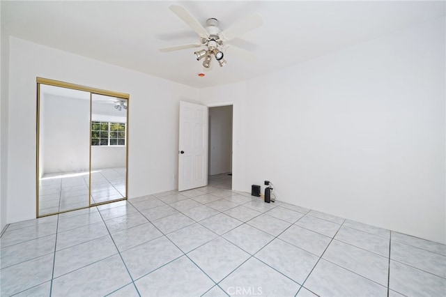 empty room featuring light tile patterned floors and ceiling fan