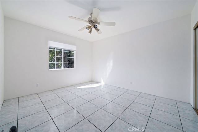 unfurnished room featuring light tile patterned floors and ceiling fan