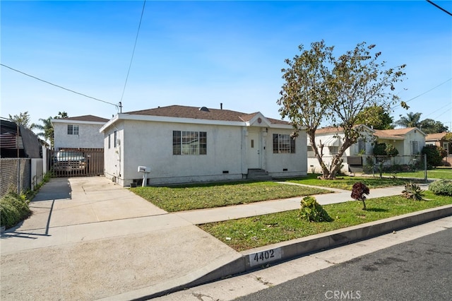 ranch-style house with stucco siding, a front lawn, driveway, fence, and crawl space