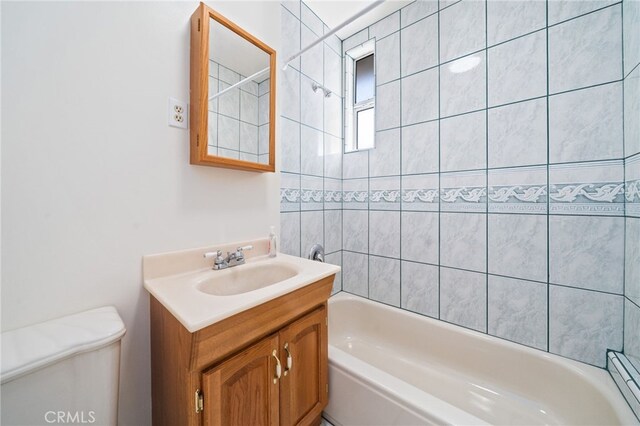 full bathroom with toilet, vanity, and washtub / shower combination