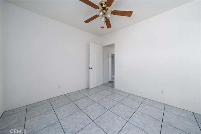 spare room featuring light tile patterned floors and ceiling fan