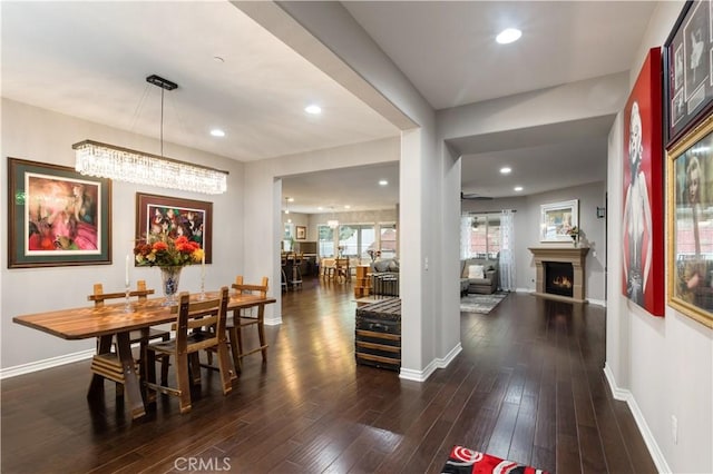 32529 Presidio Hills Ln, Winchester, CA 92596 - dining space with baseboards, dark wood finished floors, a warm lit fireplace, and recessed lighting