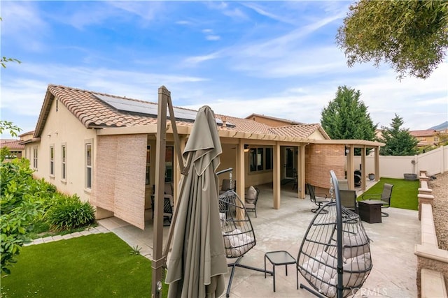 32529 Presidio Hills Ln, Winchester, CA 92596 - back of property featuring a tile roof, roof mounted solar panels, a patio, stucco siding, and fence