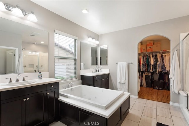 32529 Presidio Hills Ln, Winchester, CA 92596 - full bath with a stall shower, a tub with jets, two vanities, and a walk in closet