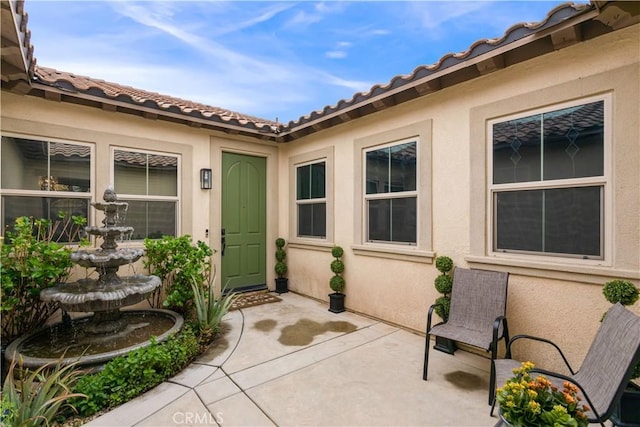 32529 Presidio Hills Ln, Winchester, CA 92596 - property entrance featuring stucco siding, a patio, and a tile roof