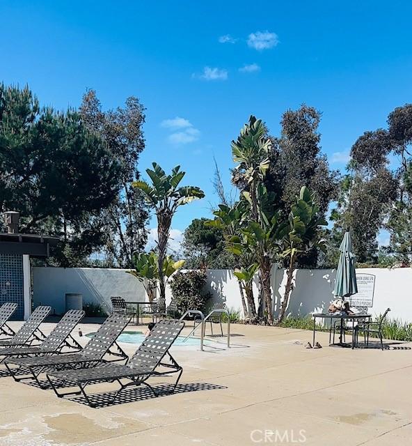 view of pool featuring a patio, fence, and a pool