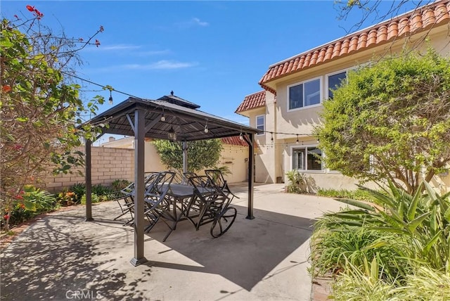 view of patio with a gazebo and fence