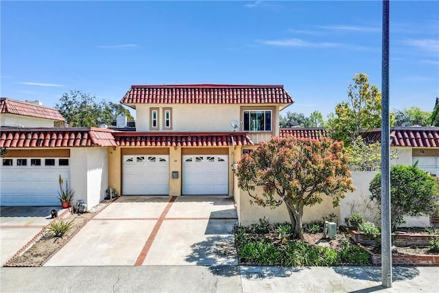 mediterranean / spanish-style home with stucco siding and driveway