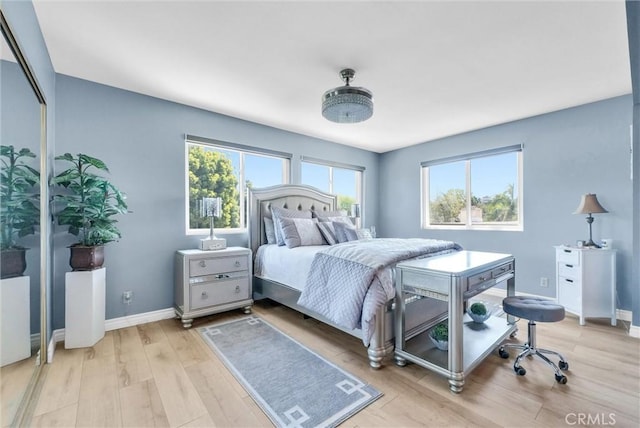 bedroom featuring baseboards and light wood-style floors