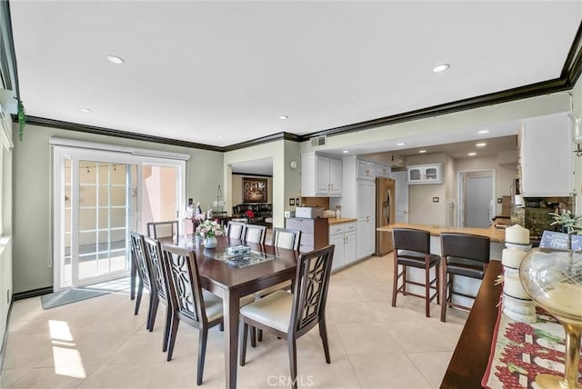 dining area featuring light tile patterned floors, ornamental molding, and visible vents
