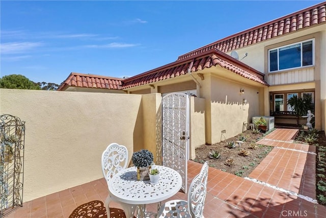 view of patio featuring fence and a gate