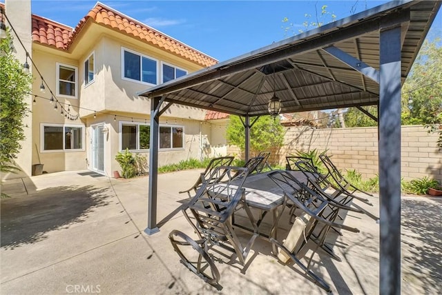 view of patio / terrace with fence and a gazebo