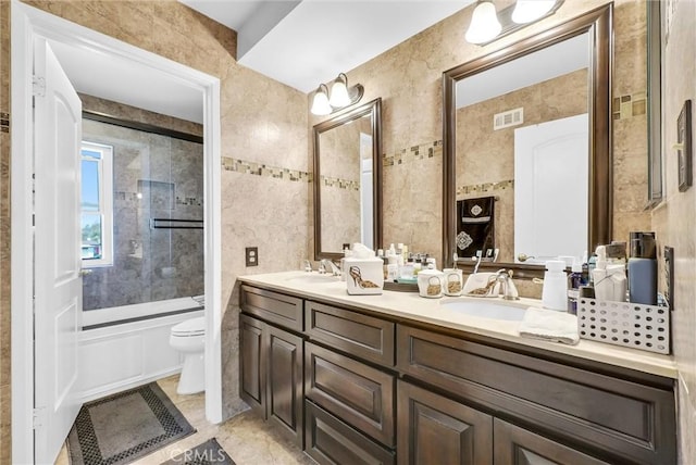 full bathroom featuring a sink, toilet, double vanity, and visible vents