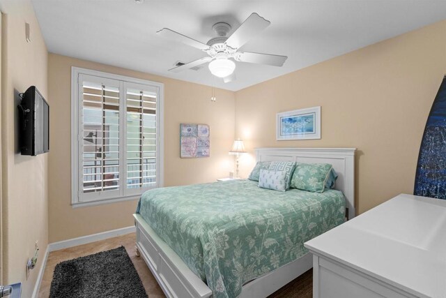 carpeted bedroom featuring ceiling fan and baseboards