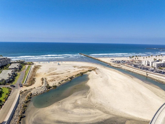 drone / aerial view with a beach view and a water view