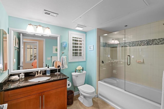 full bathroom featuring vanity, tile patterned floors, toilet, combined bath / shower with glass door, and visible vents