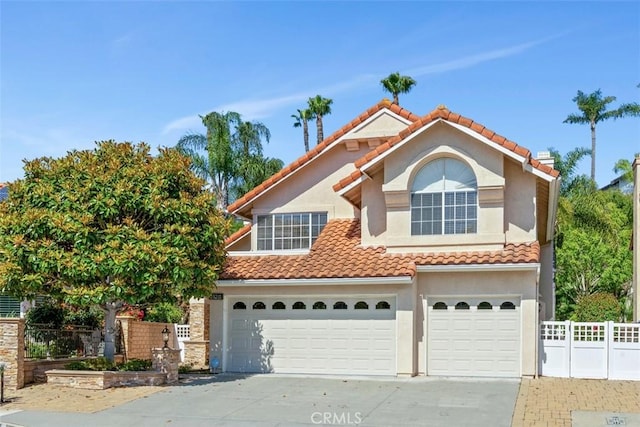 29211 Alfieri St, Laguna Niguel, CA 92677 - mediterranean / spanish-style house featuring an attached garage, concrete driveway, a tiled roof, and stucco siding