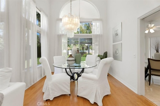 29211 Alfieri St, Laguna Niguel, CA 92677 - dining room featuring a chandelier, a high ceiling, wood finished floors, and baseboards