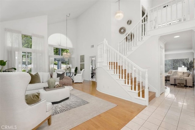 29211 Alfieri St, Laguna Niguel, CA 92677 - living area featuring high vaulted ceiling, stairway, and wood finished floors