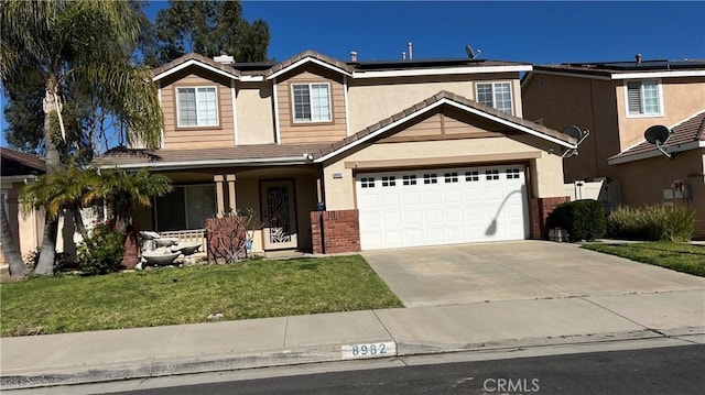 8982 Dahlia Dr, Corona, CA 92883 - view of front of home featuring roof mounted solar panels, stucco siding, a tile roof, a front lawn, and concrete driveway