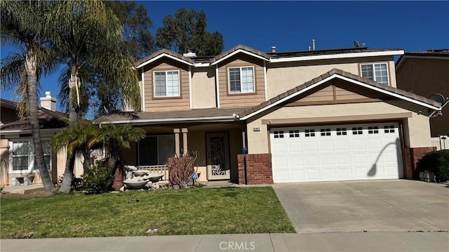 8982 Dahlia Dr, Corona, CA 92883 - view of front of home featuring driveway, stucco siding, a front lawn, and brick siding