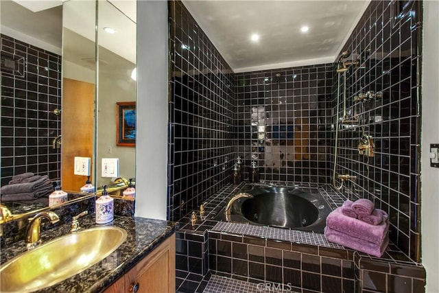 bathroom featuring a tub with jets and vanity