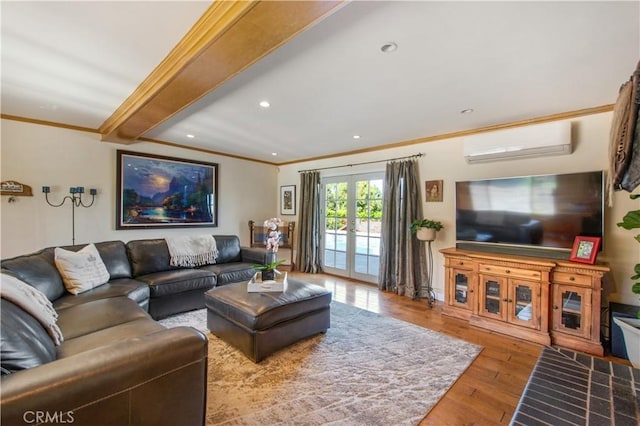 living area with french doors, ornamental molding, wood finished floors, an AC wall unit, and recessed lighting
