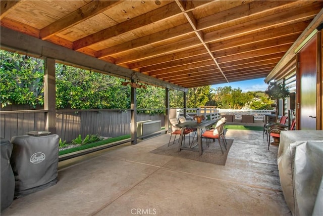 view of patio with outdoor dining area and fence