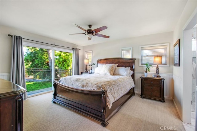 bedroom with access to exterior, multiple windows, and light colored carpet