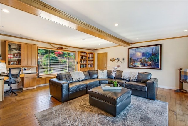 living area with ornamental molding, light wood-style flooring, recessed lighting, and beamed ceiling