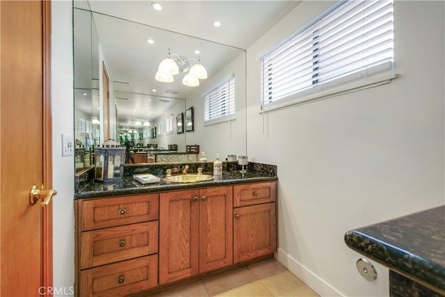 bathroom featuring a chandelier, baseboards, tile patterned floors, recessed lighting, and vanity