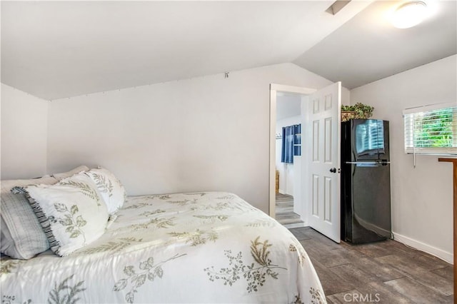 bedroom with baseboards and lofted ceiling
