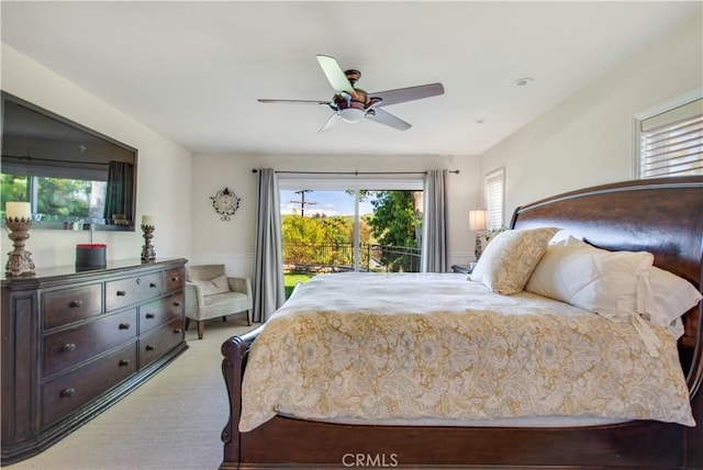 bedroom featuring a ceiling fan, access to outside, and light colored carpet