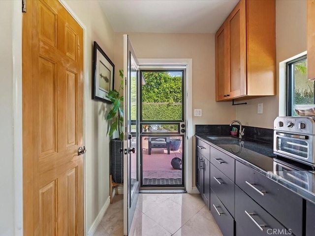 2080 Saint Louis Ave, Signal Hill, CA 90755 - doorway to outside featuring a sink, baseboards, a toaster, and light tile patterned flooring