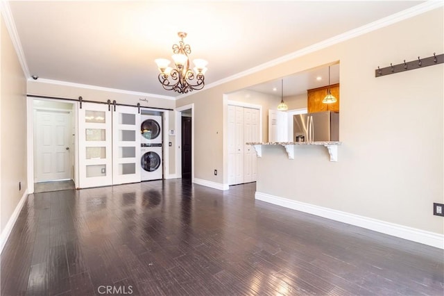 18715 Plummer St, Northridge, CA 91324 - unfurnished room featuring stacked washer / dryer, a barn door, baseboards, wood finished floors, and crown molding