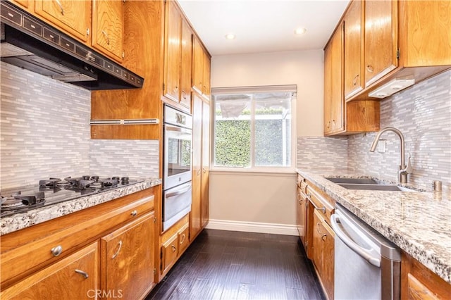 18715 Plummer St, Northridge, CA 91324 - kitchen with stainless steel appliances, under cabinet range hood, a warming drawer, a sink, and brown cabinetry