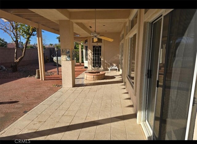 view of patio / terrace with a fenced backyard, a fire pit, and ceiling fan
