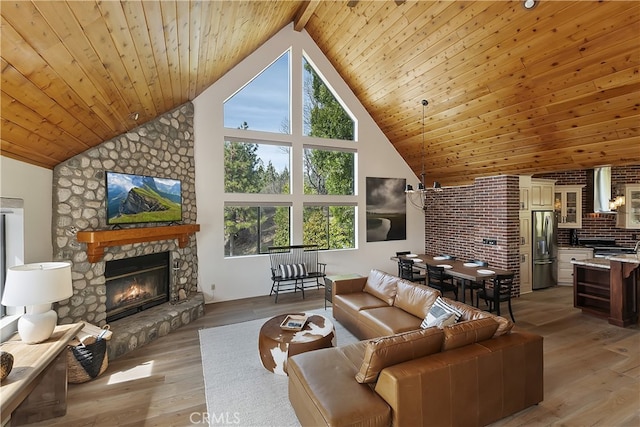 living room with a stone fireplace, wood ceiling, light wood-style floors, and high vaulted ceiling