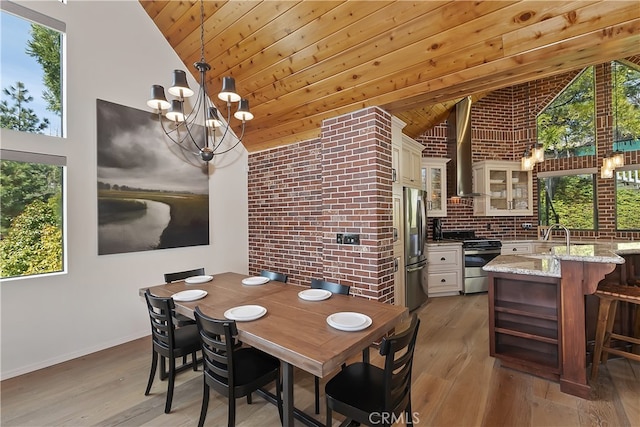 dining space with wooden ceiling, light wood-style flooring, brick wall, and a chandelier