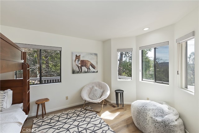 sitting room featuring a healthy amount of sunlight, light wood-type flooring, and baseboards