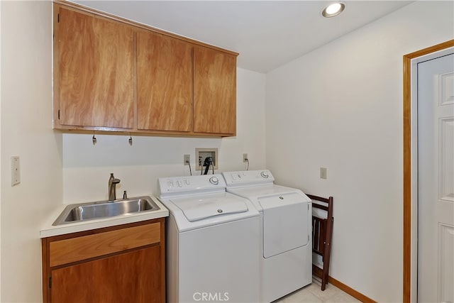 washroom featuring baseboards, recessed lighting, cabinet space, independent washer and dryer, and a sink