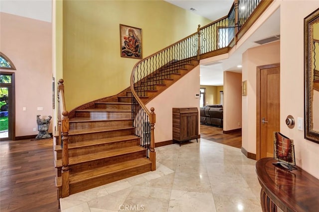 24925 Vista Verenda, Woodland Hills, CA 91367 - stairway featuring a towering ceiling and baseboards