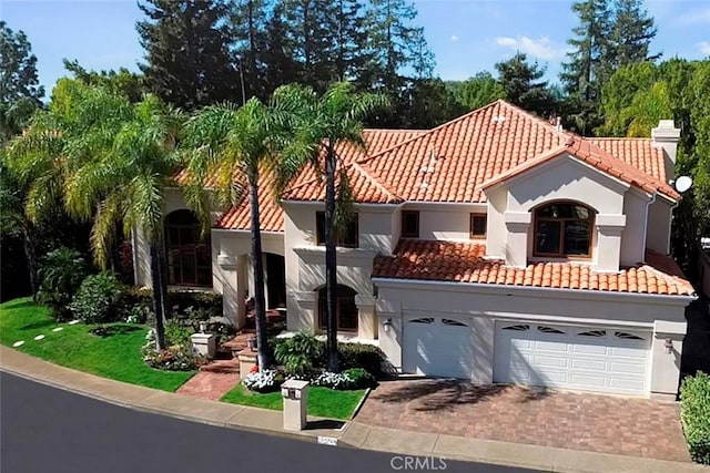 24925 Vista Verenda, Woodland Hills, CA 91367 - mediterranean / spanish-style house with a tile roof, decorative driveway, a garage, and stucco siding