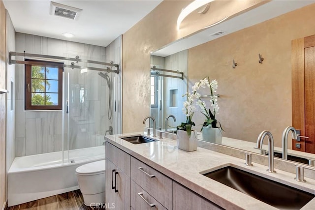 24925 Vista Verenda, Woodland Hills, CA 91367 - bathroom with toilet, double vanity, wood finished floors, and shower / bath combination with glass door