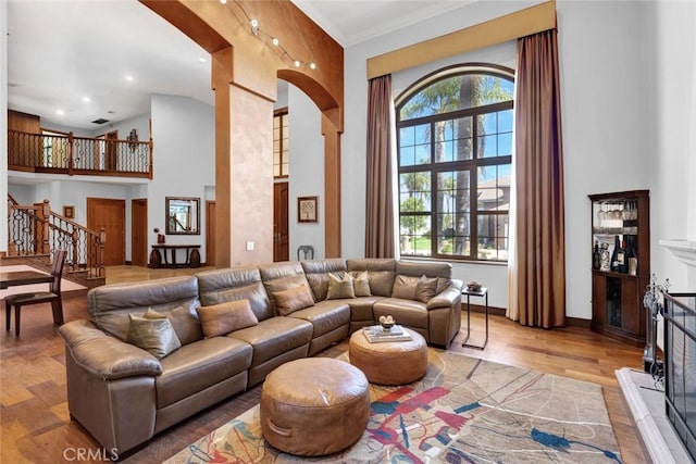 24925 Vista Verenda, Woodland Hills, CA 91367 - living area featuring a fireplace with raised hearth, stairway, wood finished floors, a high ceiling, and recessed lighting