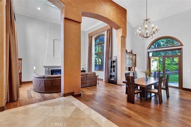 24925 Vista Verenda, Woodland Hills, CA 91367 - dining room with arched walkways, wood finished floors, a high ceiling, a chandelier, and baseboards