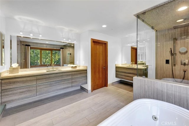 24925 Vista Verenda, Woodland Hills, CA 91367 - full bath with a tub with jets, a shower stall, wood finished floors, two vanities, and baseboards