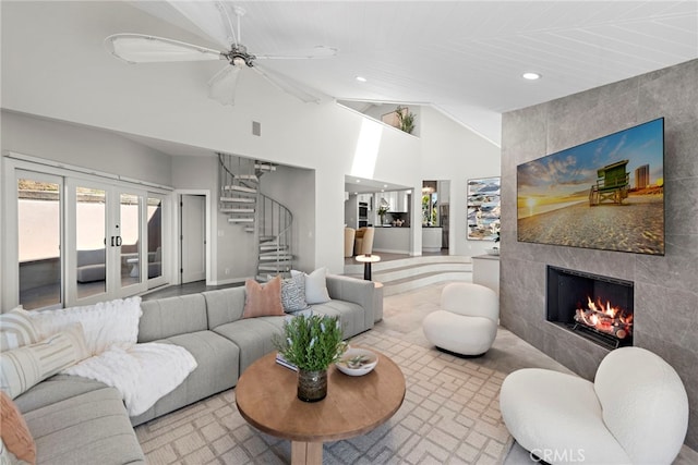 15 Vista De Catalina N, Laguna Beach, CA 92651 - living area featuring a tile fireplace, stairs, high vaulted ceiling, recessed lighting, and french doors