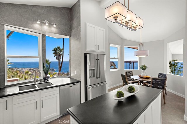 15 Vista De Catalina N, Laguna Beach, CA 92651 - kitchen featuring appliances with stainless steel finishes, a sink, dark countertops, white cabinets, and lofted ceiling