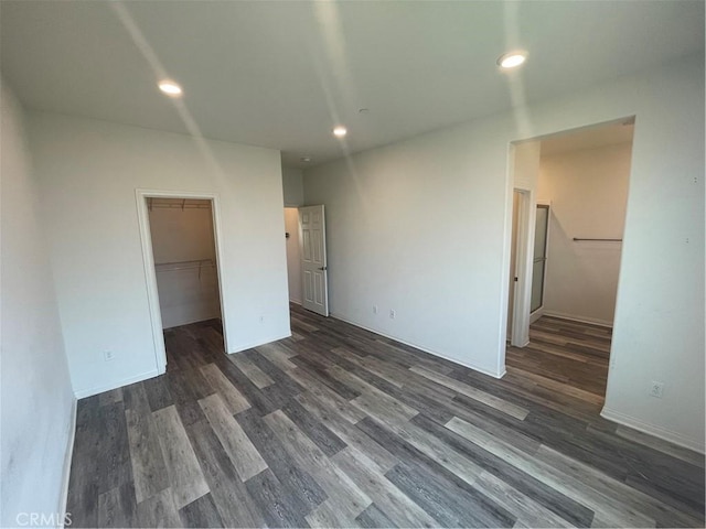 unfurnished room with recessed lighting and dark wood finished floors